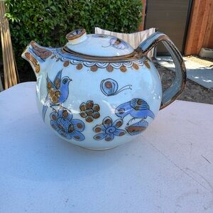 Blue and Brown Ceramic Art with Elegant Floral Patterns